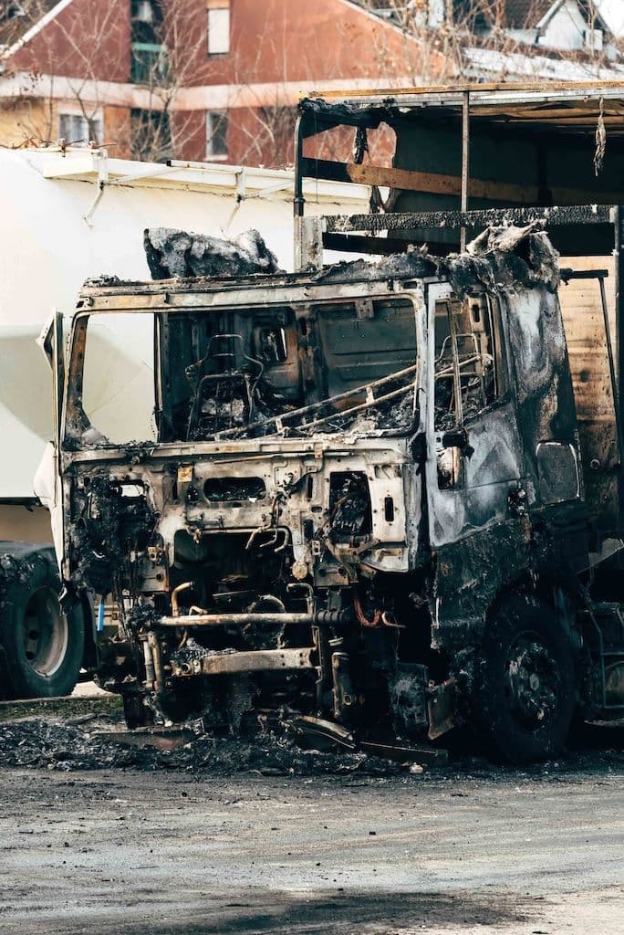 A severely damaged and scorched truck after a truck accident.